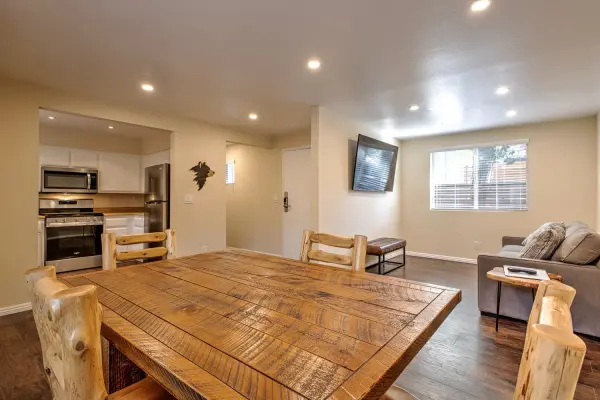 Cottage #70 at Tahquitz Pines Retreat, a rustic dining table with log chairs, an open kitchen and a sitting area