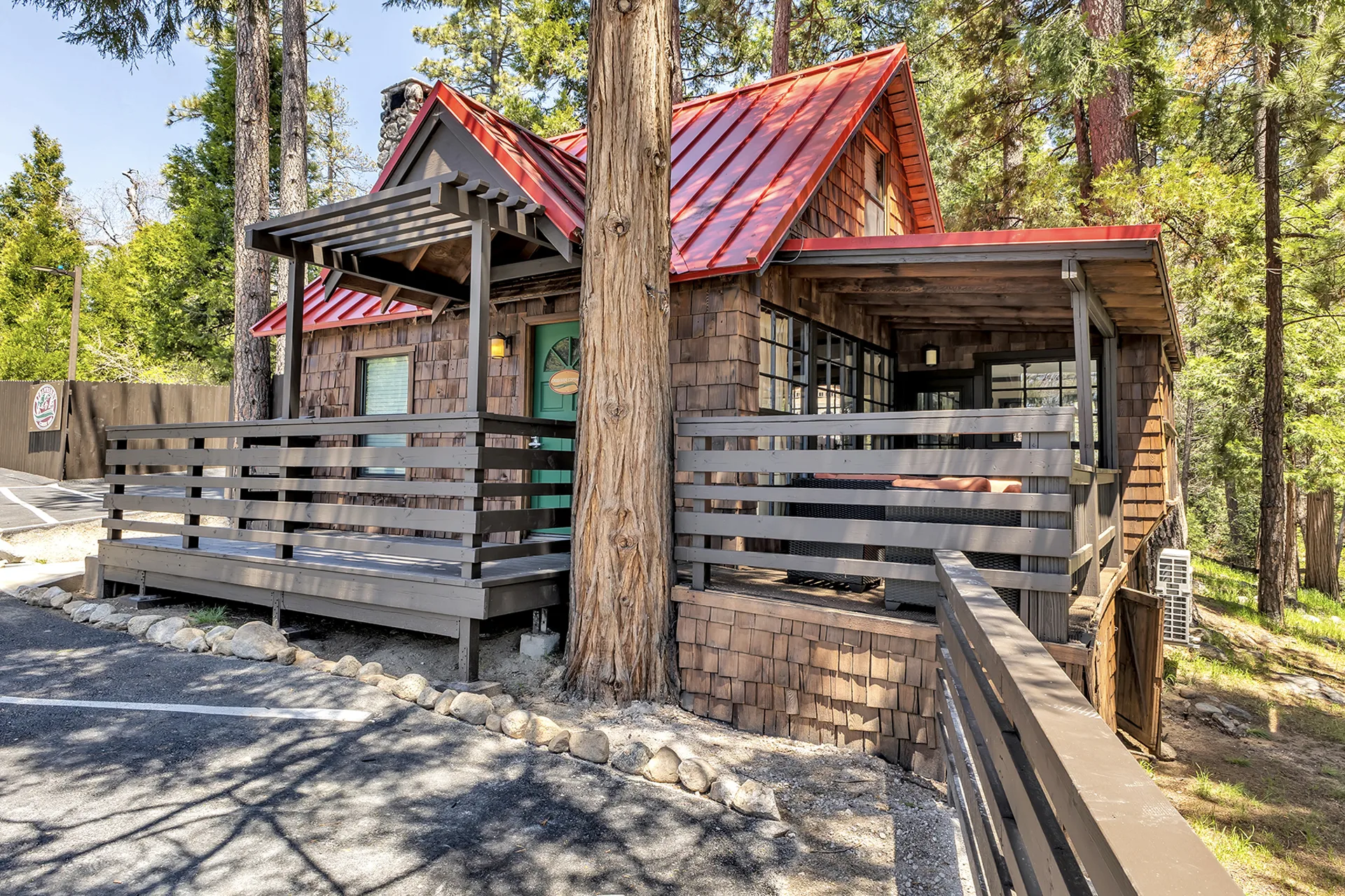 Creekside Cabin at Strawberry Creek Inn, its deck and red roof among the pines